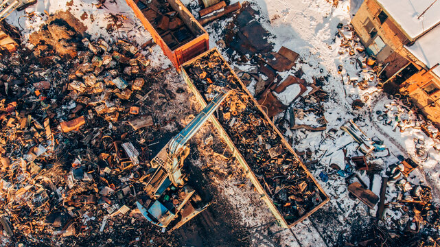 Aerial Photography Of Scrap Metal Dump, Crane Unloads, Loads Scrap Metal In A Railway Car.