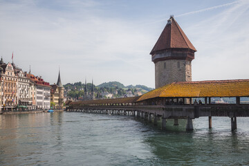 The famous pedestrian Chapel Bridge (Kapellbrcke) over the Reuss River in Lucerne, Switzerland on a bright sunny day