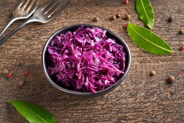 Obraz na płótnie Canvas Fermented purple cabbage in a bowl on a table