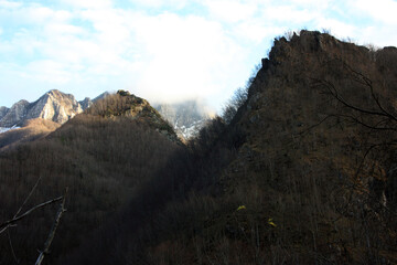 mountain peaks of the Apuan Alps in the cold haze