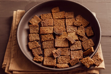 In the center, on a wooden table, is a cast-iron frying pan with fried buttery crusty bread