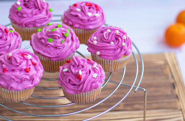  candy bar, top view. muffins with bright cream and sugar decor. Cupcakes with cream. mini cakes are laid out in a circle. dessert. High quality photo