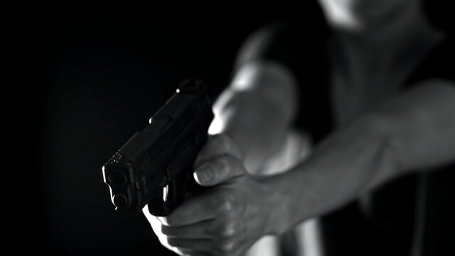 A Woman's hands holding a .45 caliber handgun. Female training and concealed carry concept