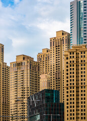 Fototapeta na wymiar Yellow Dubai Marina skyscrapers in UAE. Multistory residential Estate