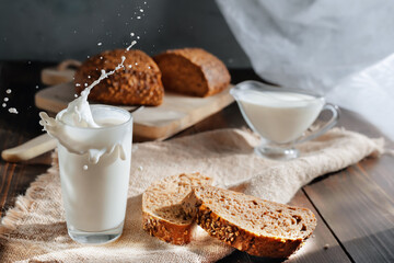 milk splashing in glass and whole-grain bread