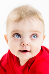 The face of a beautiful child with blue eyes and long eyelashes, close-up.