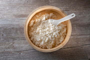 Steamed rice in wooden mixing bowl