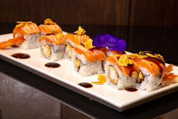 a tray with excellent sushi of rice, salmon and shrimp