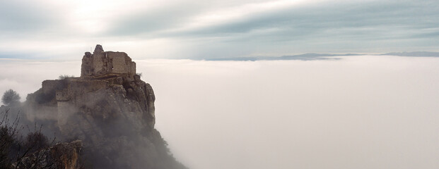 French winter landscapes. Stunning panoramic view of castle ruins Crussol. Foggy mountain...