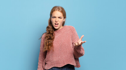blonde pretty woman looking angry, annoyed and frustrated screaming wtf or what’s wrong with you