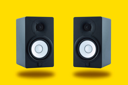 Pair of professional high quality monitor speakers for sound recording,  mixing, and mastering in studio in black wooden casing isolated on yellow  background. Stock 写真 | Adobe Stock
