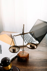 Business and lawyers discussing contract papers with brass scale on desk in office. Law, legal services, advice, justice and law concept  picture with film grain effect