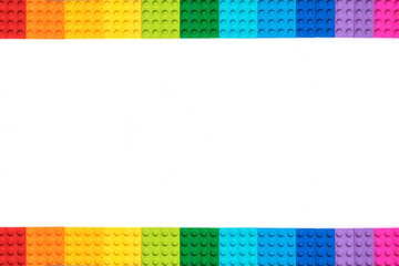 Frame of Multicolor Bricks constructor bricks on white background. Popular toys.