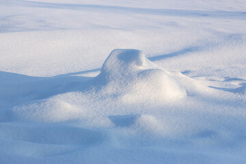 Snowdrift and shadow. Snowy background, winter snow texture on a sunny evening.