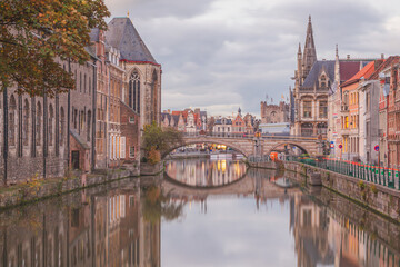 The beautiful historic old town of Ghent, Belgium along the Leie Canal at dusk.