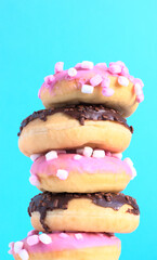 Tower of donuts about to fall. Cholesterol concept. Junk food concept.