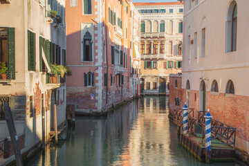 Fototapeta na wymiar A sunny day on a quiet Venetian canal in Venice, Italy.