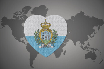 puzzle heart with the national flag of san marino on a world map background.