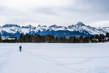 solo skier in front of mountain range