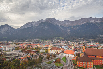 Naklejka na ściany i meble High cityscape and mountain view of Innsbruck, Austria in autumn.