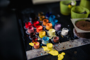 Close-up of tattoo pigment of different colors in boxes into needles