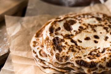 A stack of buttered crepes. Preparation of pancakes on a pan. Shrovetide or pancake week.