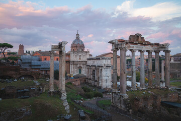 Fototapeta na wymiar Evening sunset view of historic ruins of the Roman Forum and Palatino Hill in Rome, Italy, a popular tourist attraction.