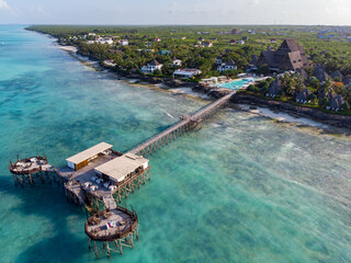 Northern Coast of Zanzibar at Nungwi with Lighthouse and Thatched-roof Restaurant on Pillars Above the Ocean