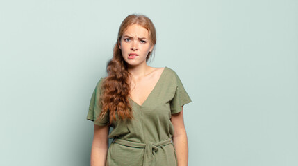 blonde pretty woman feeling clueless, confused and uncertain about which option to pick, trying to...