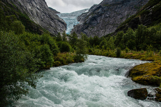 The glacial flour laden Briksdalselva river flowing down from the Briksdalbreen Glacier, Norway.