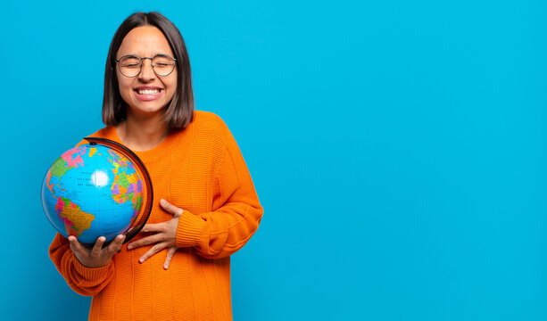 young hispanic woman laughing out loud at some hilarious joke, feeling happy and cheerful, having fun - Powered by Adobe