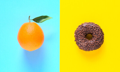 Diet food choice, healthy diet or junk food. Blue and yellow background. Isolated donut. Colorful...