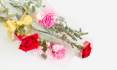 Colorful,fresh flowers in transparent boxes on white surface.