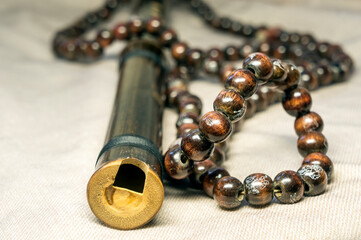 The opening of the Chinese flute and religious rosary beads on canvas © В. Дресвянников