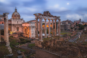 Obraz na płótnie Canvas Evening view of historic ruins of the Roman Forum and Palatino Hill in Rome, Italy.