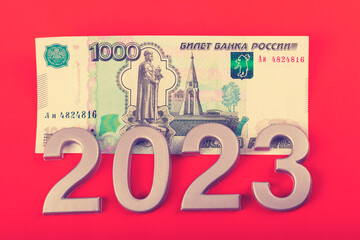 close-up. Black background. on it are numbers 2023 and a bill of 1000 rubles. Russia.