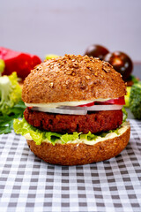 Tasty hamburger made with vegetarian plant based imitation minced meat burger and fresh vegetables