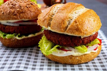 Tasty hamburger made with vegetarian plant based imitation minced meat burger and fresh vegetables