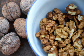 Walnuts harvest on vintage metal background. Walnut kernels from village garden. Organic autumn nuts harvest.