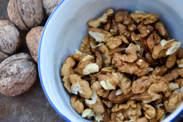 Walnuts harvest on vintage metal background. Walnut kernels from village garden. Organic autumn nuts harvest.