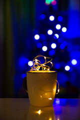 Garland in a circle on the background of a Christmas tree, blurr. Comfort and New Year's romance.