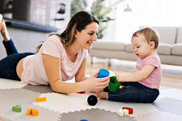 woman playing with her baby in the living room