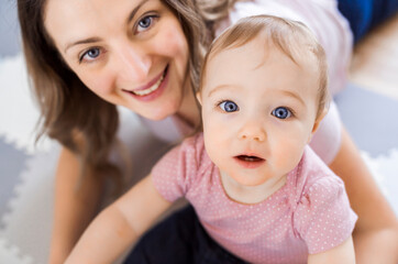 woman playing with her baby in the living room