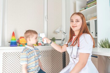 children's doctor checks the temperature of the child. medical examination of the child