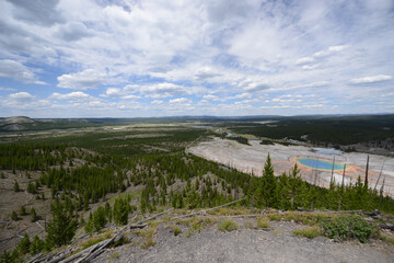 View of the Grand Prismatic Spring at Yellowstone National Park from a high viewpoint on a cloudy day