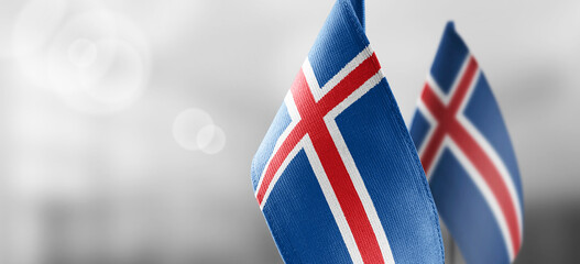 Small national flags of the Iceland on a light blurry background © butenkow