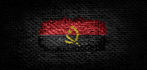 National flag of the Angola on dark fabric