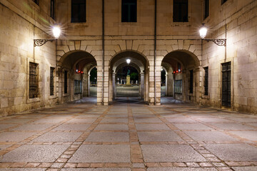 Burgos main square with the arches facade of the town hall at night. Spain