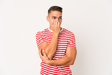 Young caucasian handsome man isolated biting fingernails, nervous and very anxious.