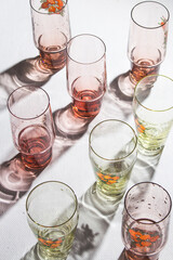Glasses of water with back lightning and beautiful shadows on the white table. copy space	